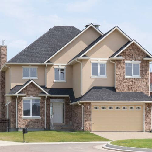 exterior of home with stone veneer siding and shingle roofing